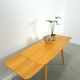 Vintage veneer table with pretty angular legs and brass at the base of the legs.