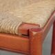 Set of two red vintage wooden chairs from the 1970s with woven rattan seats