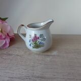 Old small artisanal milk jug in flowered speckled stoneware from the 1980s