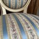 Pair of Louis XVI style chairs in painted wood and satin, classic elegance.
