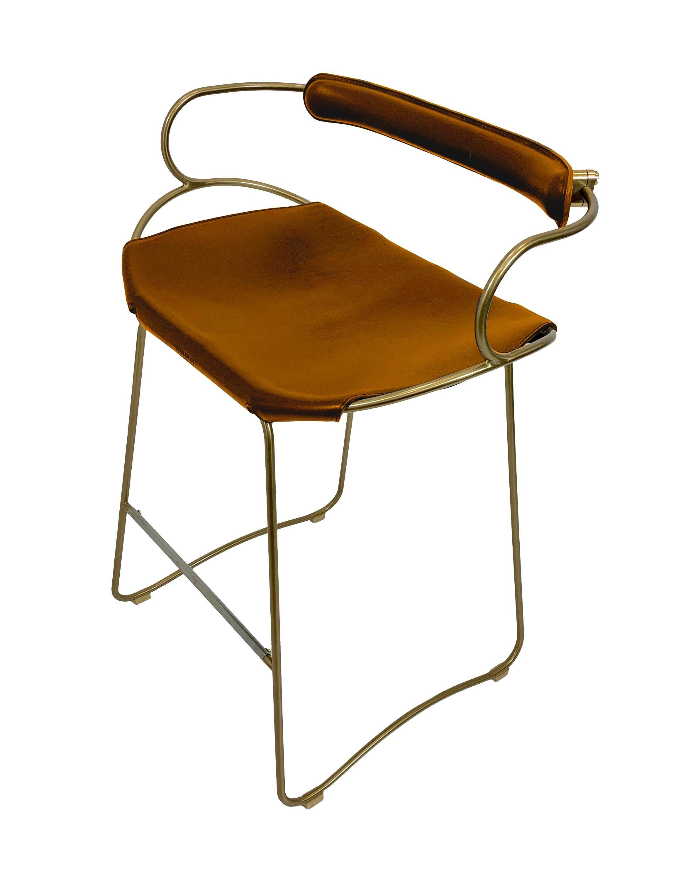 Kitchen bar stool with a brass metal backrest and natural tan tobacco leather.