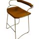 Kitchen bar stool with a brass metal backrest and natural tan tobacco leather.