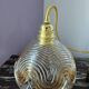 Suspension with amber moulded glass globe featuring wavy patterns.