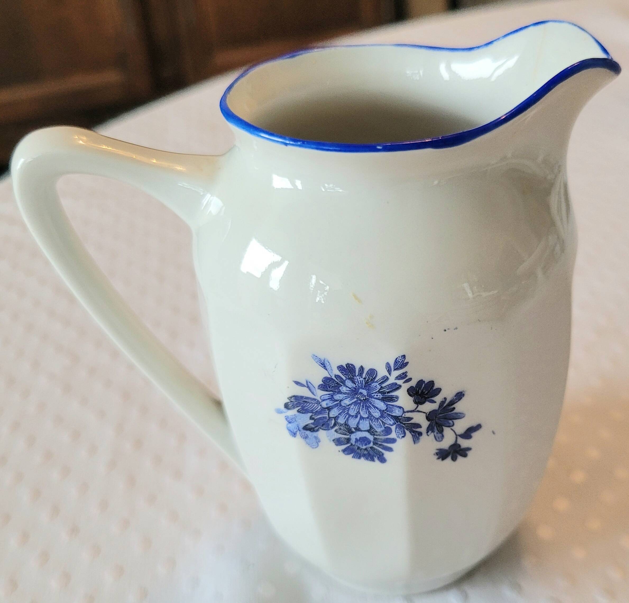 Blue and white ceramic coffee service with flowers.
