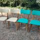 Set of 4 vintage chairs in wood and imitation blue leather dating from the 50s. Wooden structure. Seat and backrest in imitation leather 2 mint green and 2 yellow. Seating dimension: 46 cm. Good state of conservation, some traces of wear.