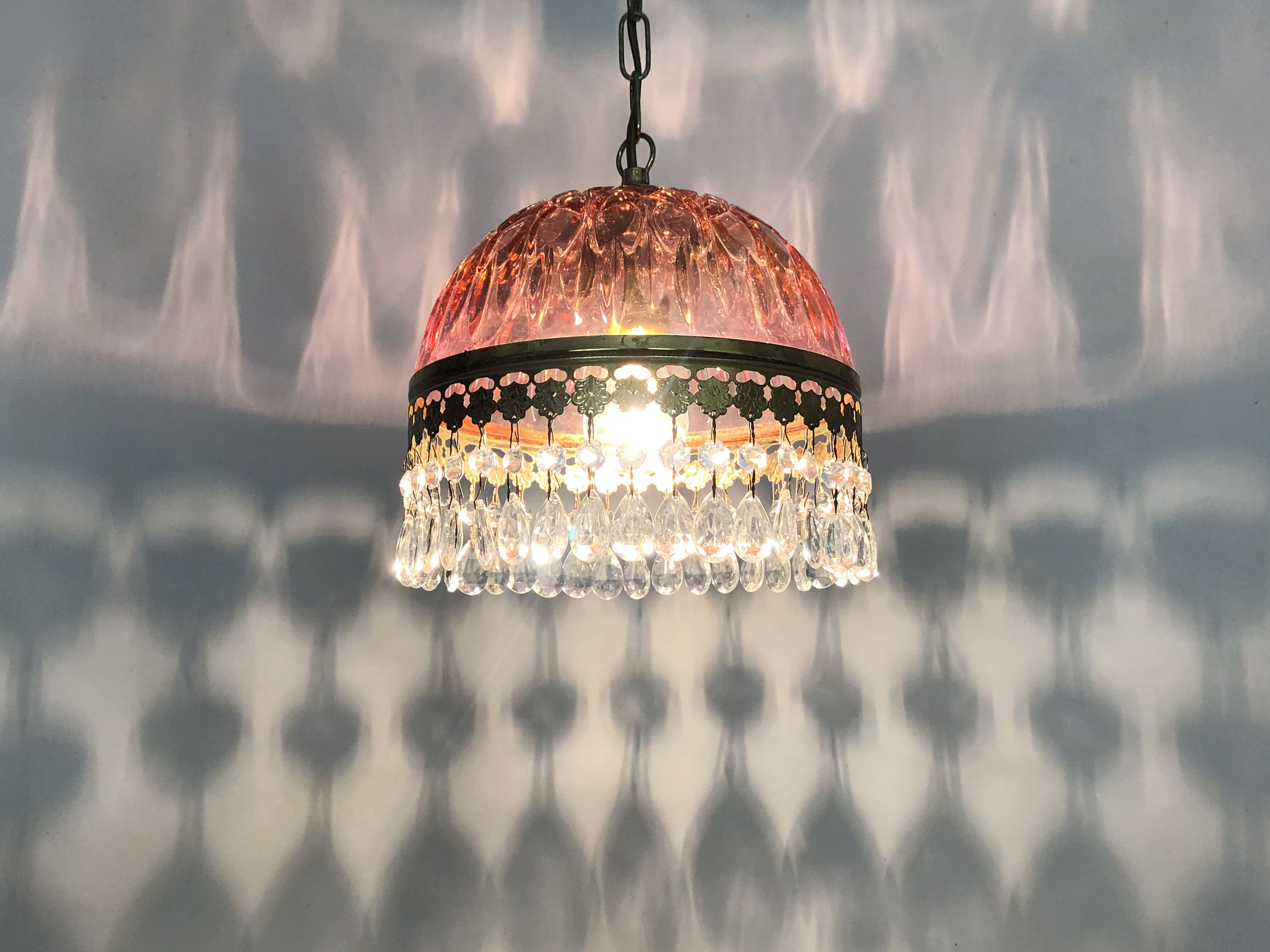 Vintage rose pendant light with pendants and patterned glass globe.