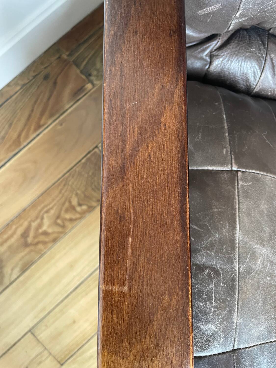 1970s Scandinavian armchair in curved laminated wood with a leather seat.