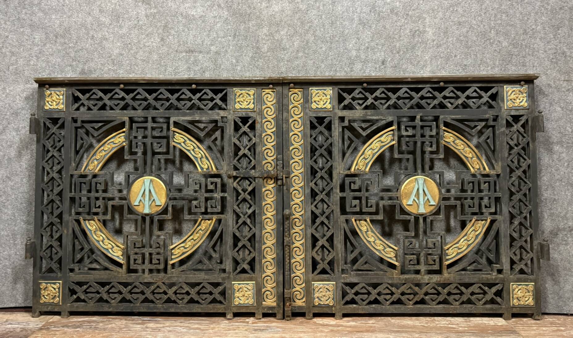 pair of monogrammed cast iron doors from the Art Deco period