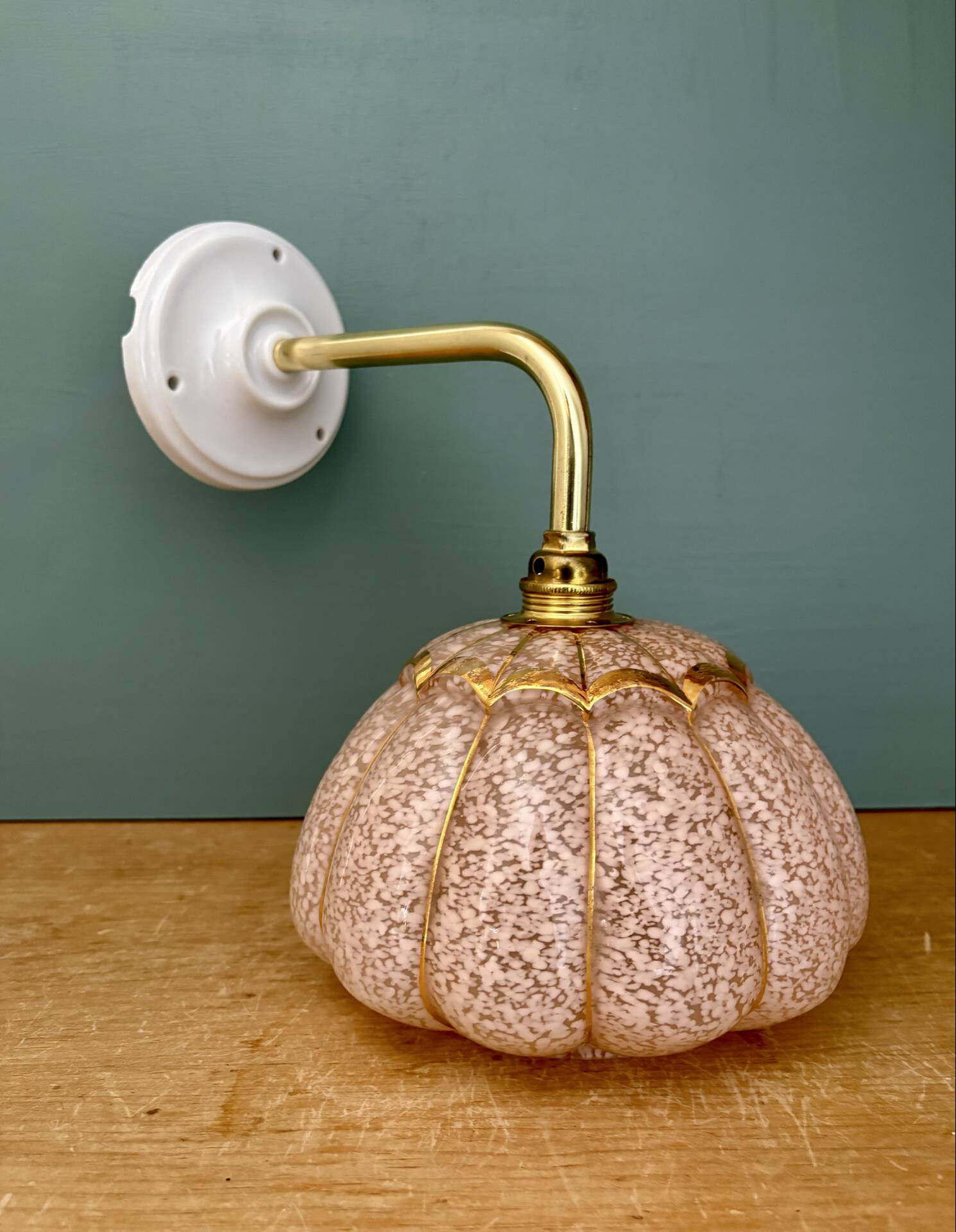 Vintage glass wall light with a pink and gold Clichy globe.
