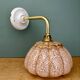 Vintage glass wall light with a pink and gold Clichy globe.