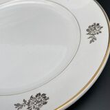 Round serving dish with small flower pattern and silver border
