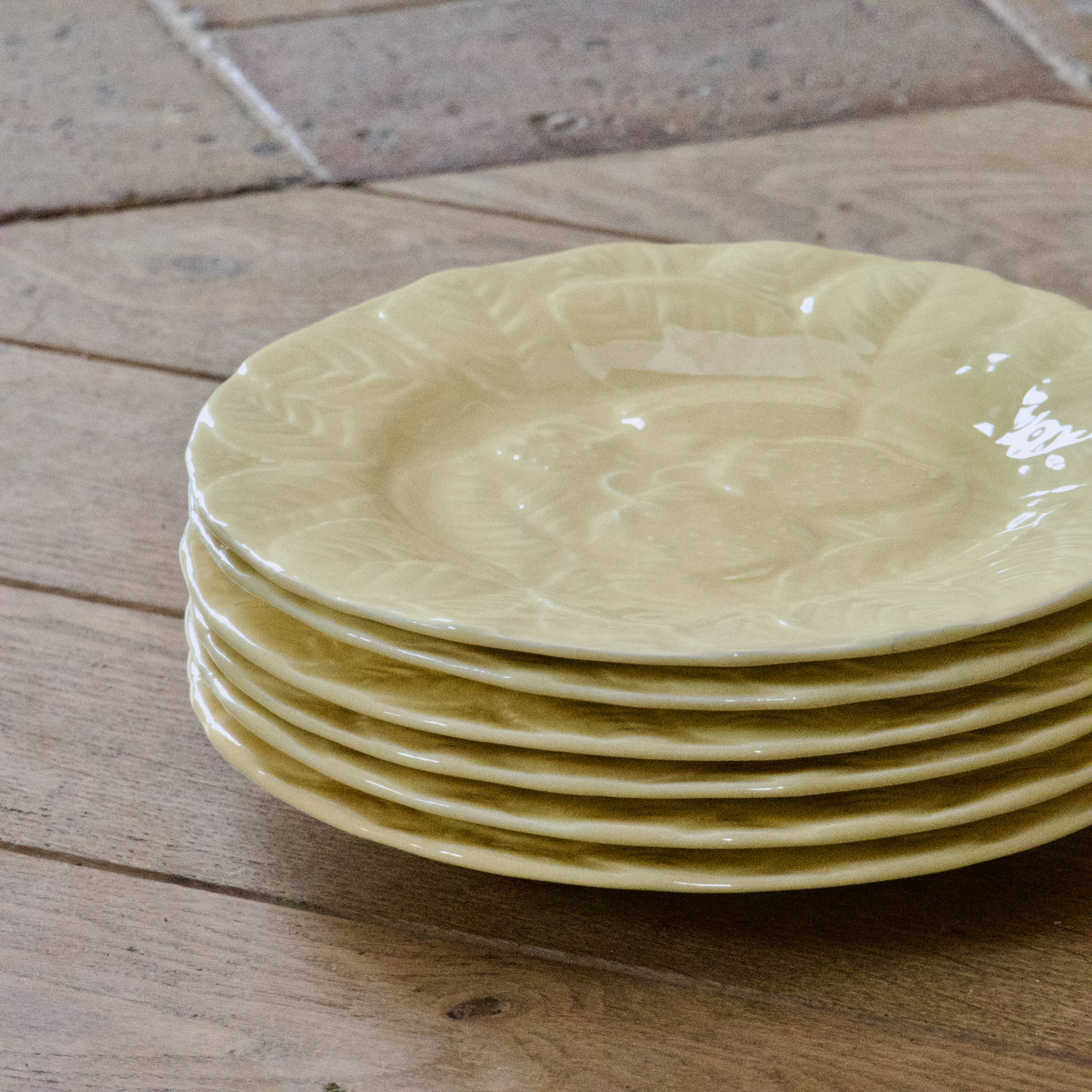 Yellow strawberry slipware plates signed Genevieve Lethu