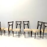Ensemble de six chaises de salle à manger en hêtre noirci avec revêtement en skaï ivoire, Italie