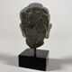 Sculpture of a Buddha head in grey schist from Gandhara, ancient Greece.