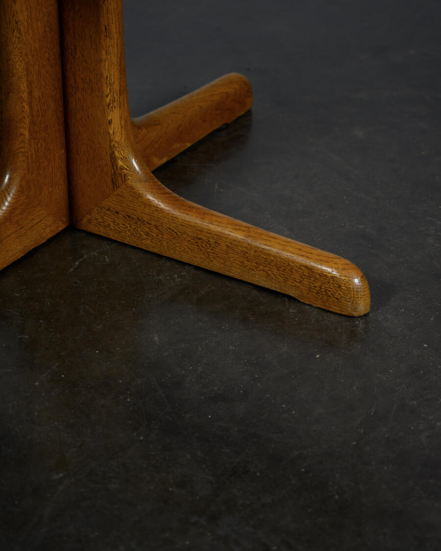 Round teak table with an extension.