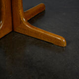 Round teak table with an extension.