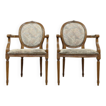 Pair of Louis XVI armchairs with medallion backs.