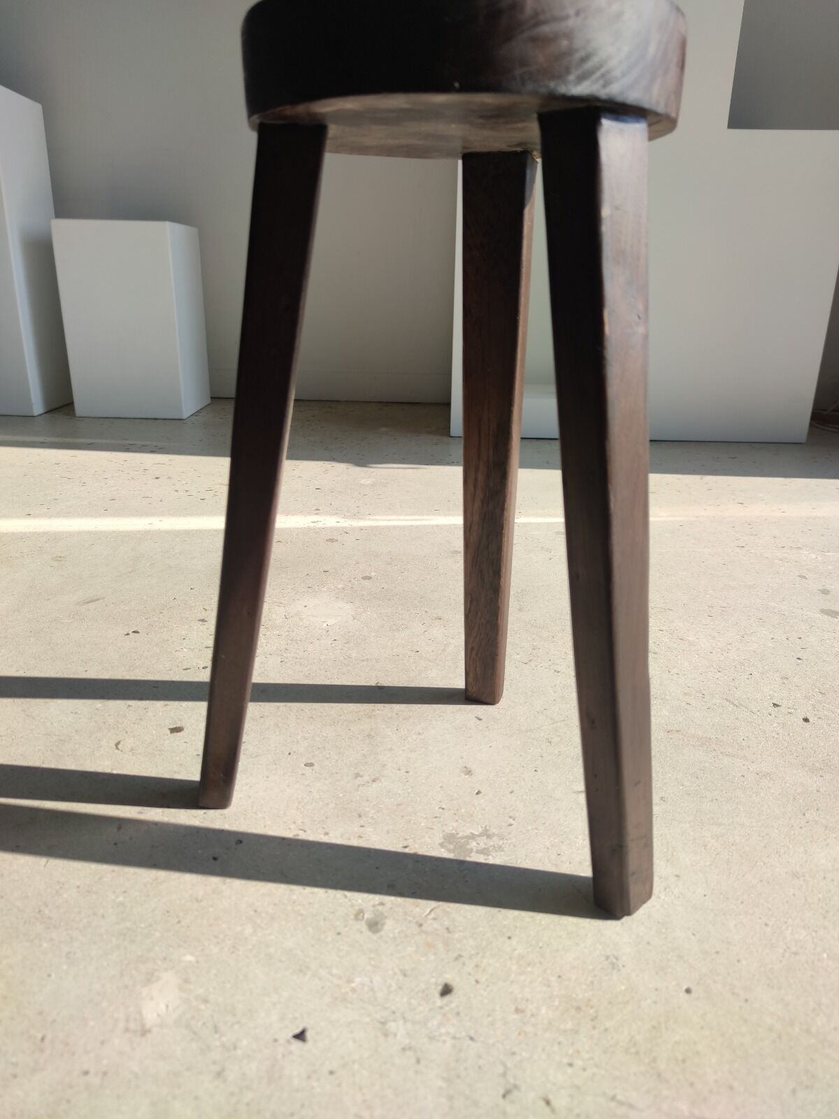 Small high tripod stool in brown solid wood