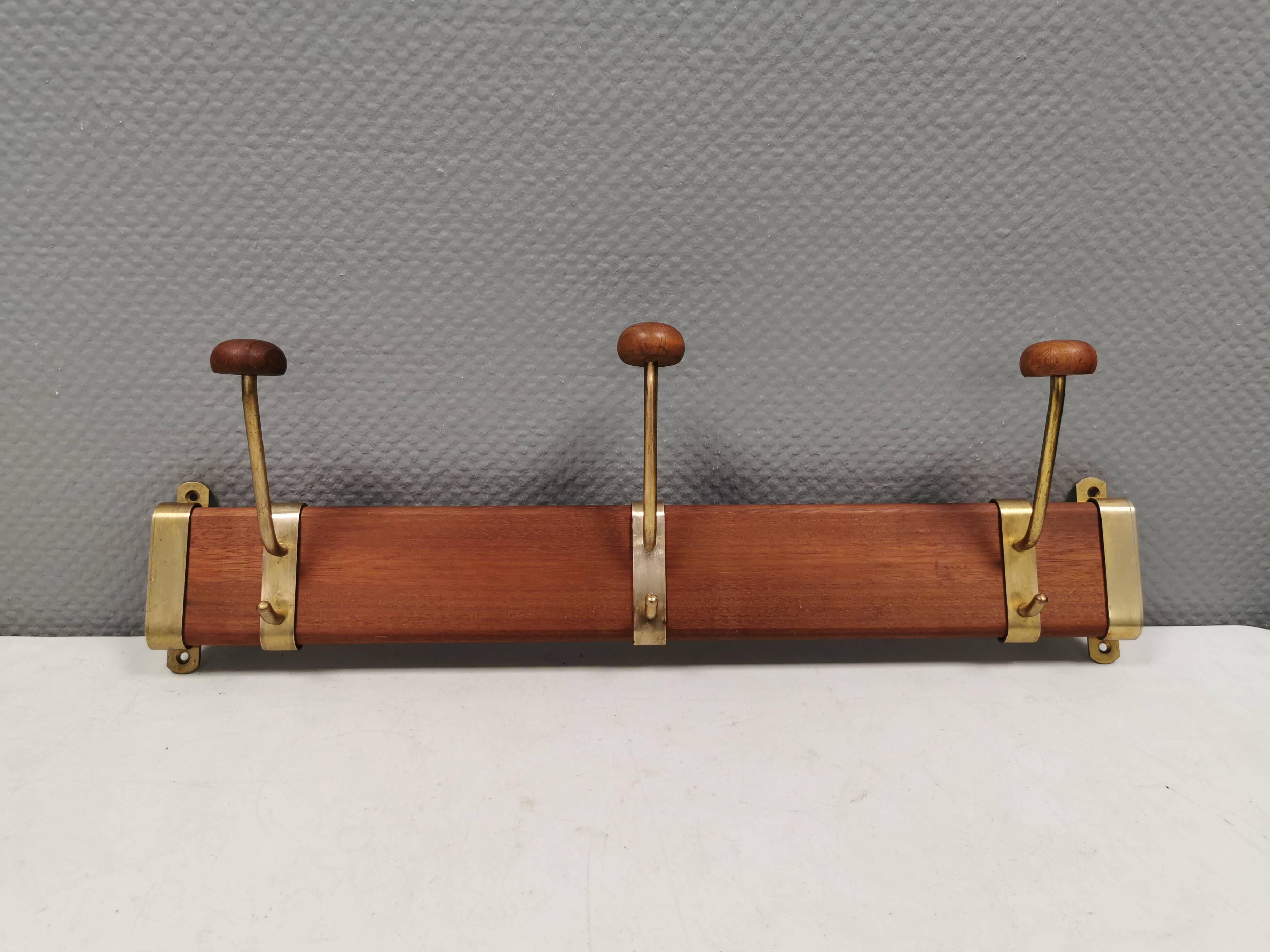 Danish teak and brass coat rack with adjustable hooks, 1960s.