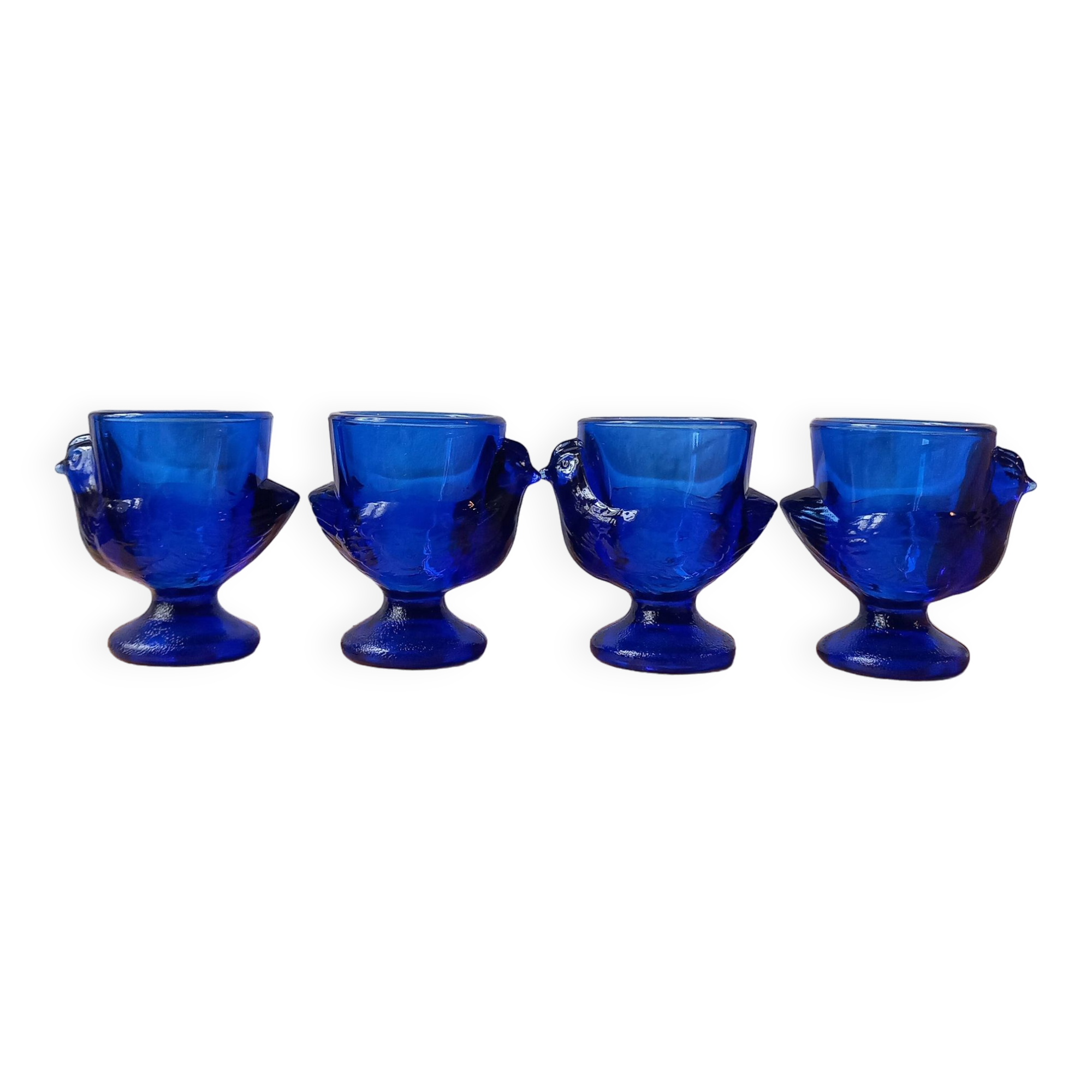 4 chicken-shaped egg cups in cobalt blue glass
