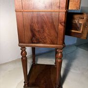 Antique wooden bedside table with turned legs.