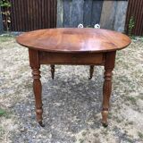 Louis Philippe oval shuttered table in solid cherry wood with 2 drawers.