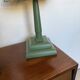 Pair of vintage wooden lamps with their striped beige, blue, and green shades.