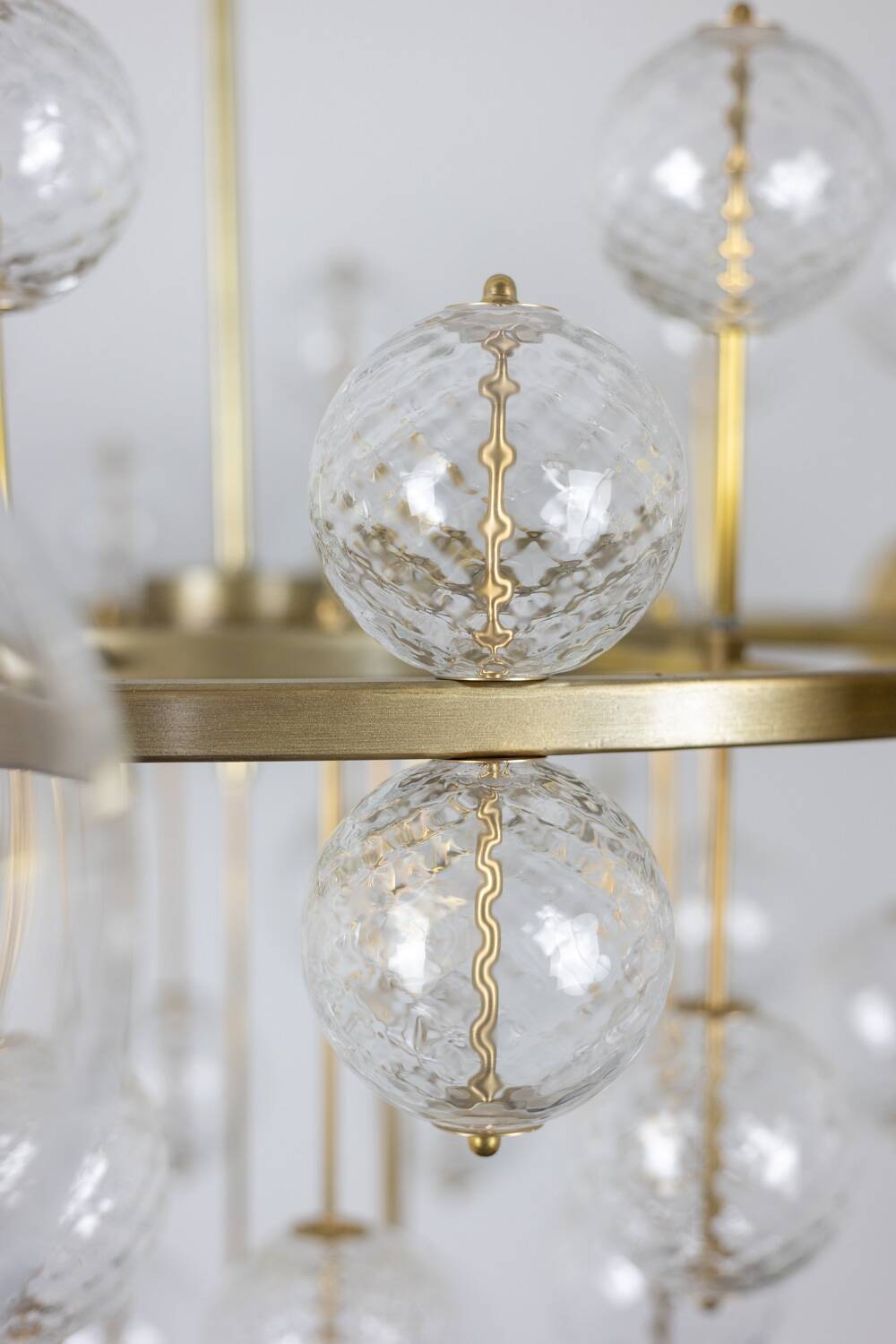 Large chandelier in gilded brass with decorative balls. 1970s.