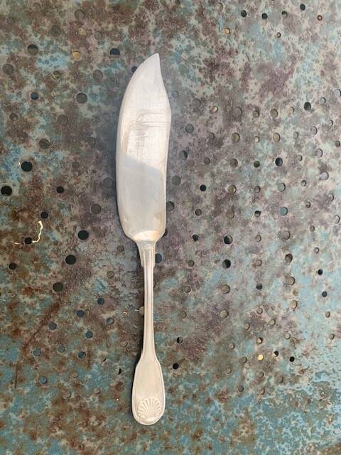 Lot of mismatched silver metal serving cutlery, a ladle and a fish knife