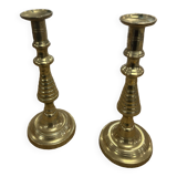 2 gold colored candlesticks
