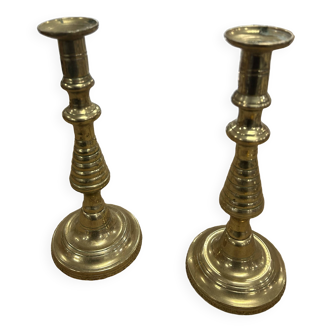 2 gold colored candlesticks