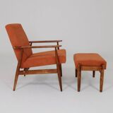 Vintage armchair and footrest in orange corduroy.
