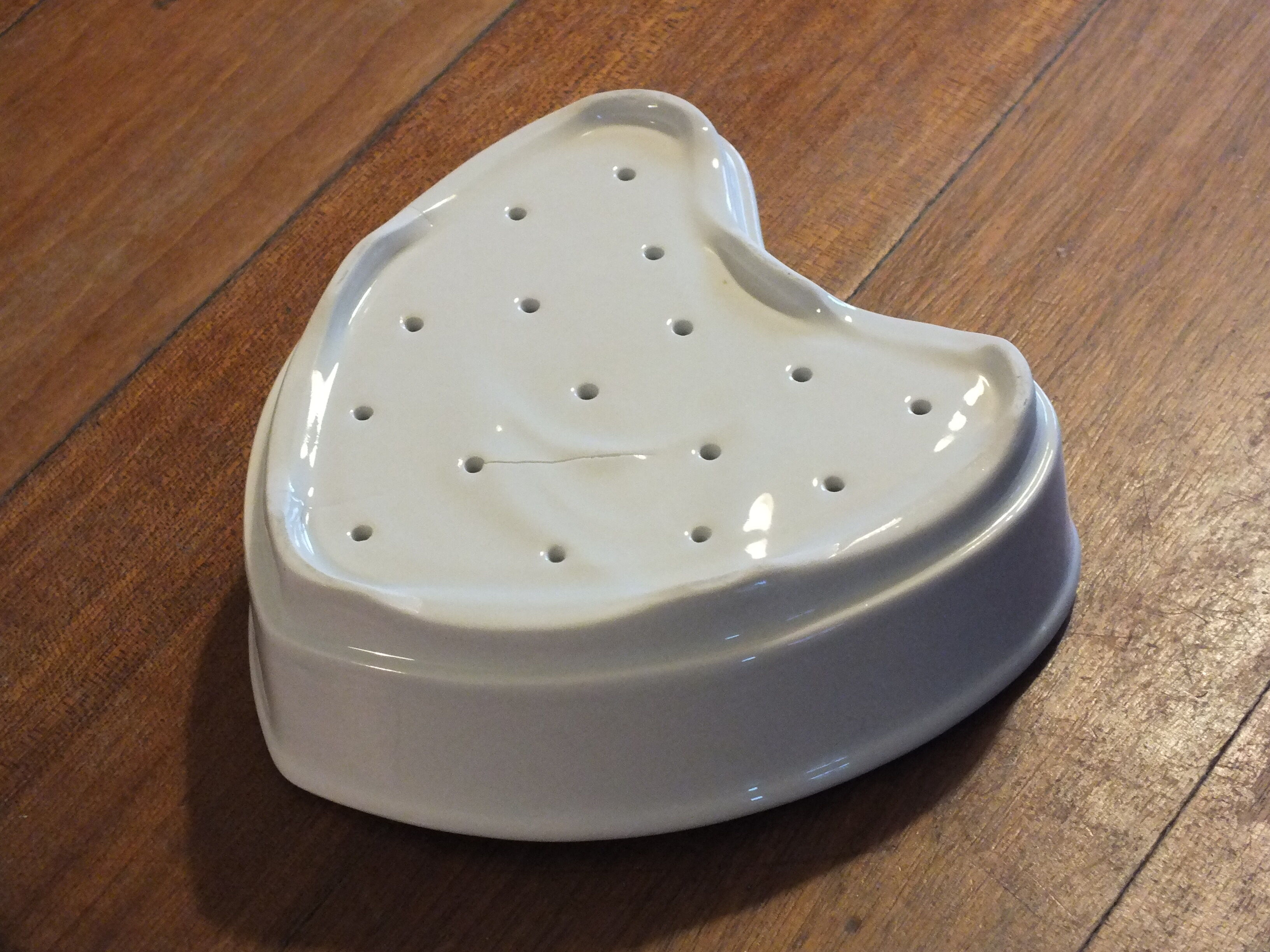 Old white porcelain heart mold (faisselle or Neufchatel)