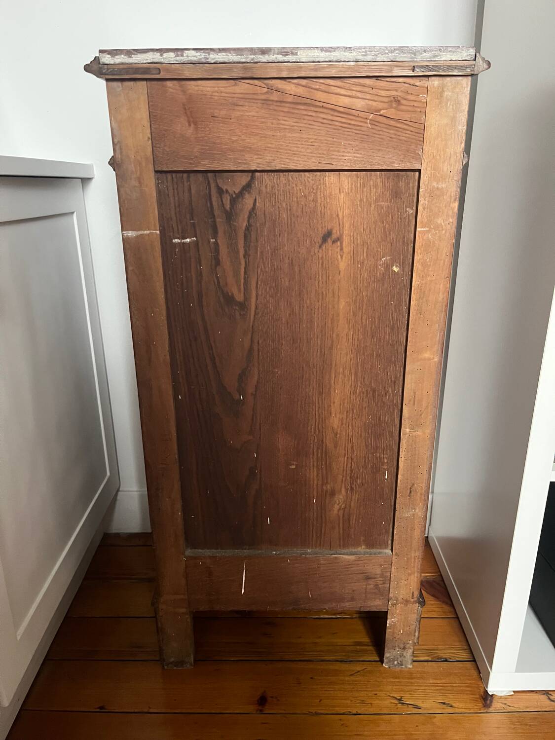 Solid wood storage furniture with a marble top.
