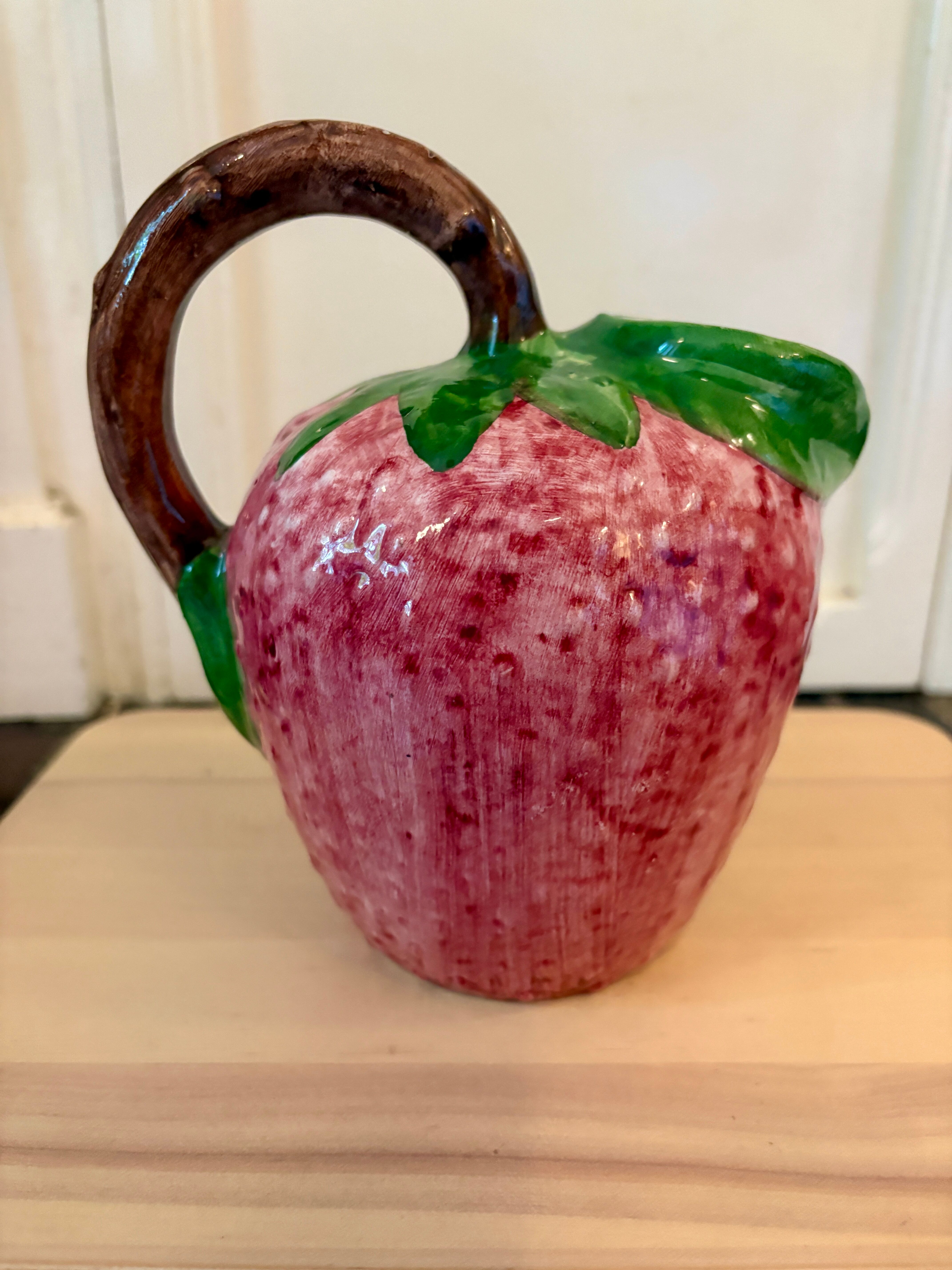 Ceramic jug in the shape of a strawberry.