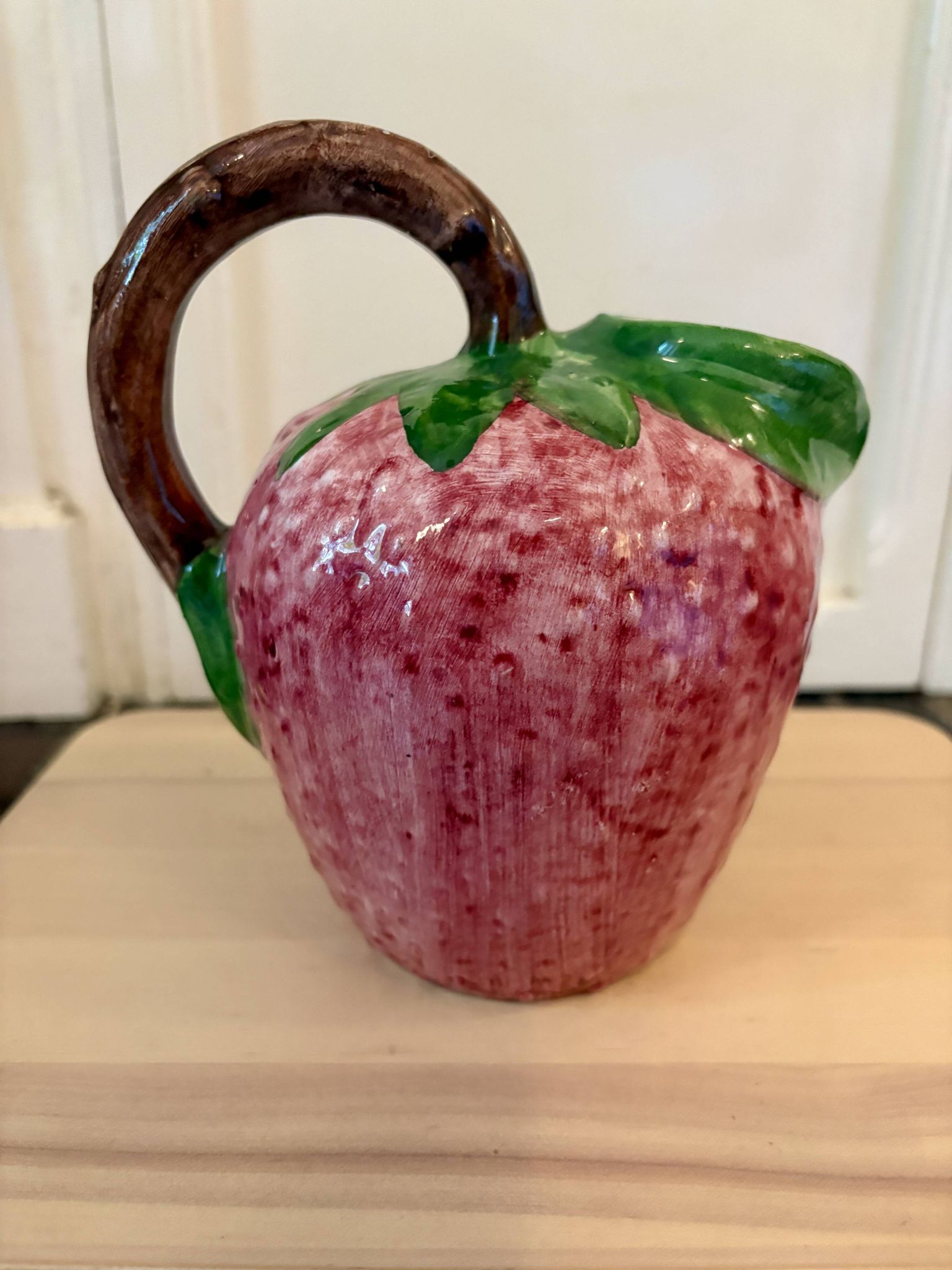 Ceramic jug in the shape of a strawberry.