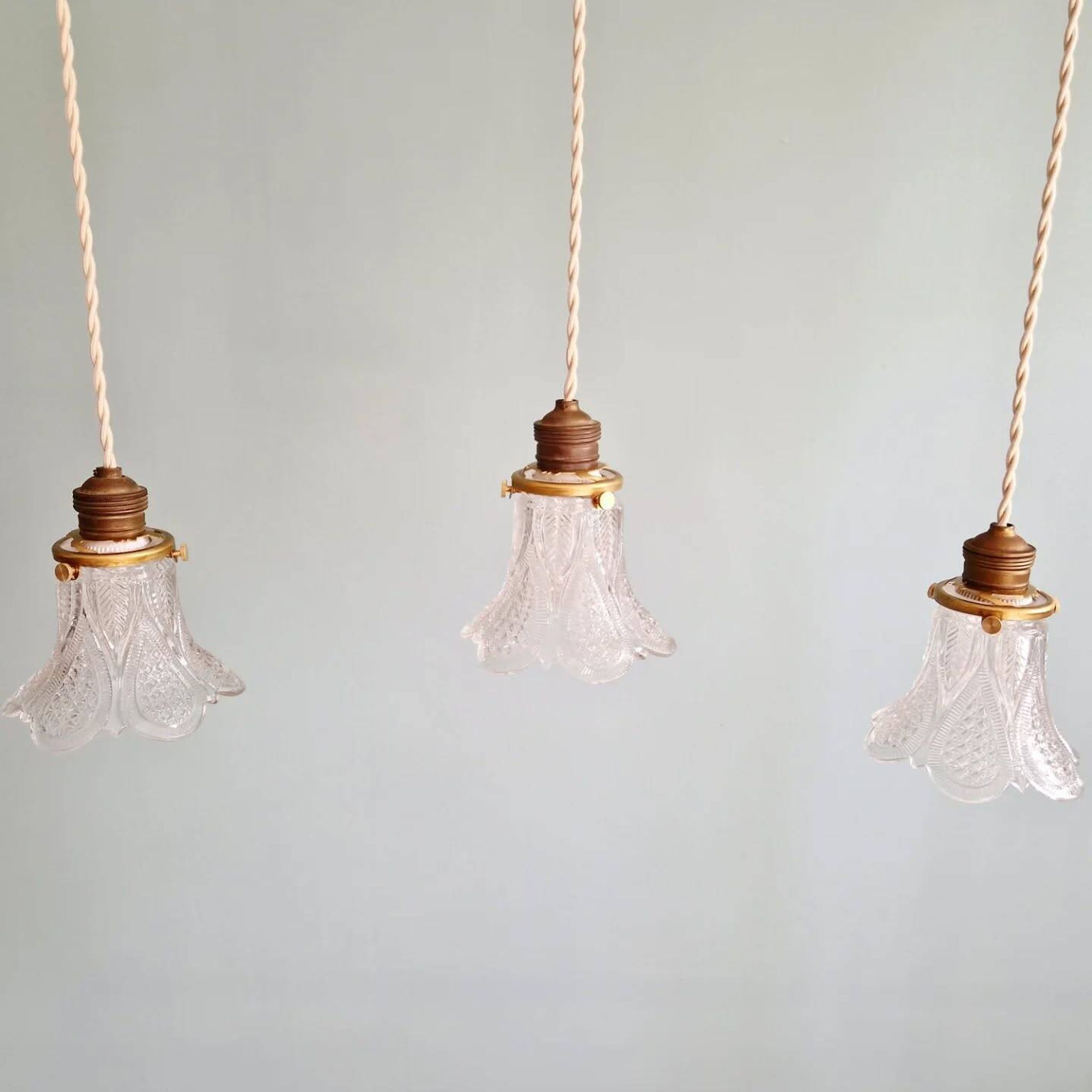Art Deco trio of pendant lights/table lamps in clear glass, 1920s-30s.