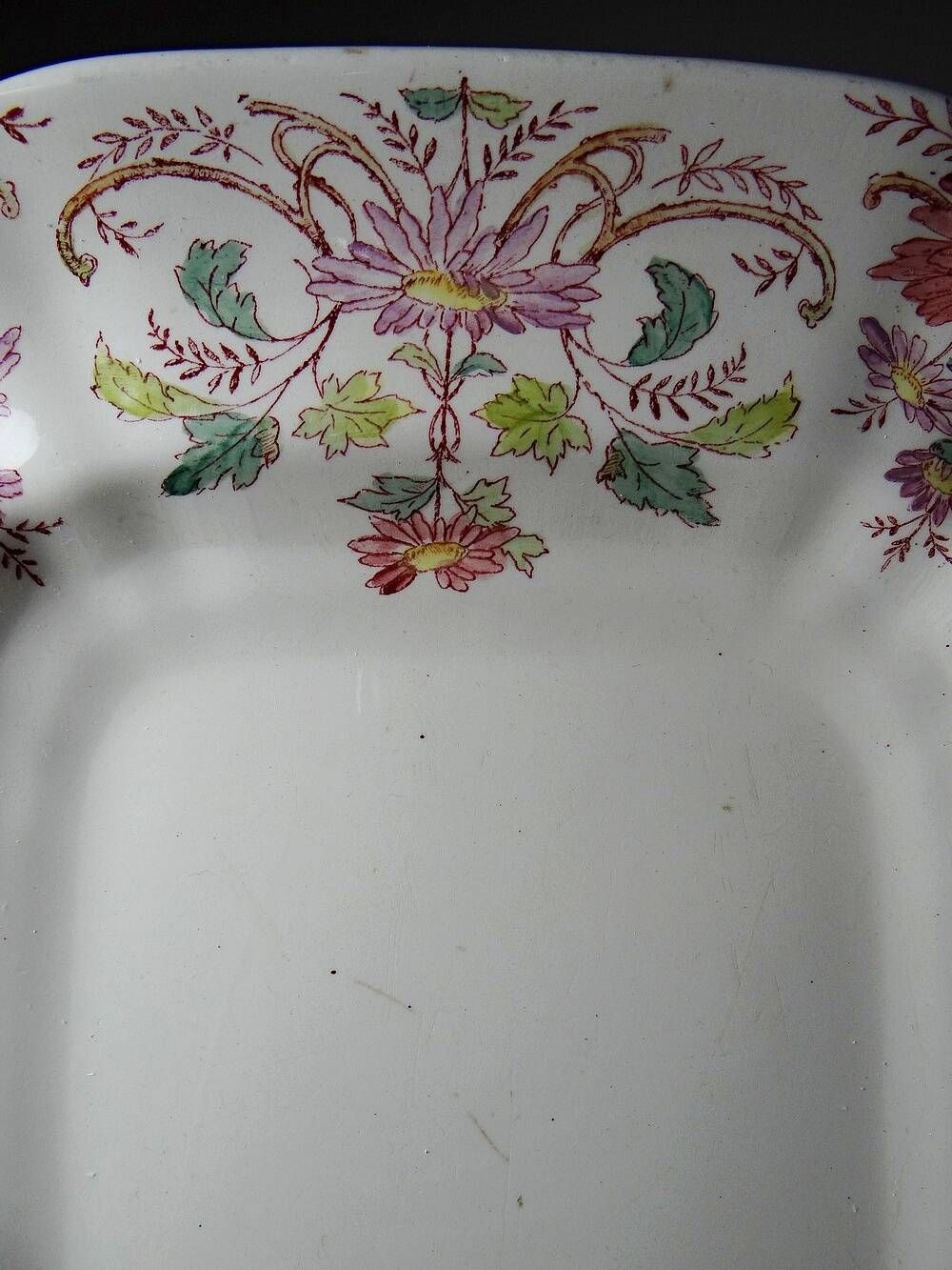 Antique Longchamp serving platter with polychrome daisies in ironstone.