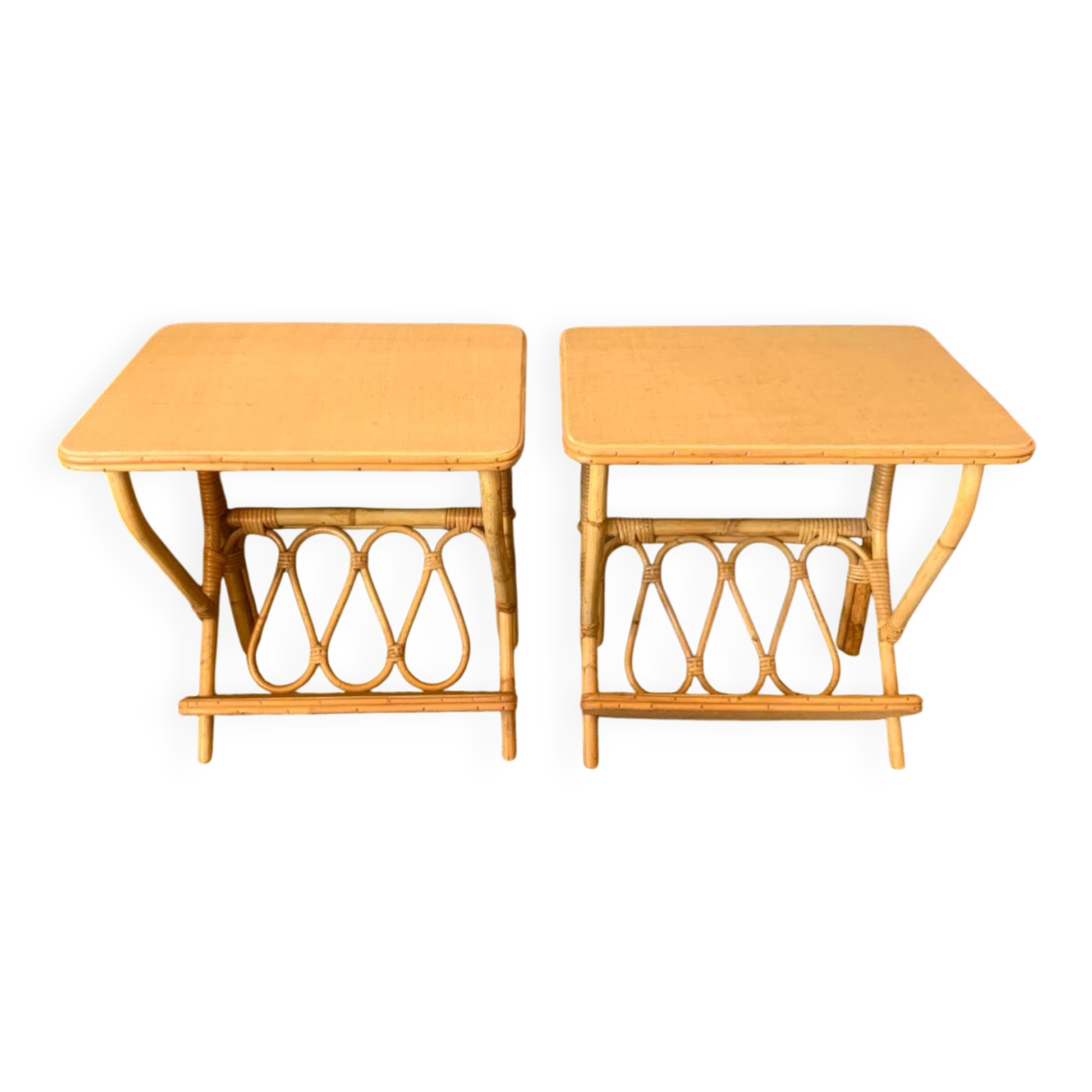 A pair of rattan bedside tables.