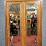 Armoire a miroirs style louis XVI en noyer a patine blonde vers 1880