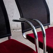 Set of 4 cantilever chairs with burgundy seat and mesh backrest.