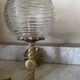 Pair of neoclassical wall sconces in twisted brass and ribbed glass.