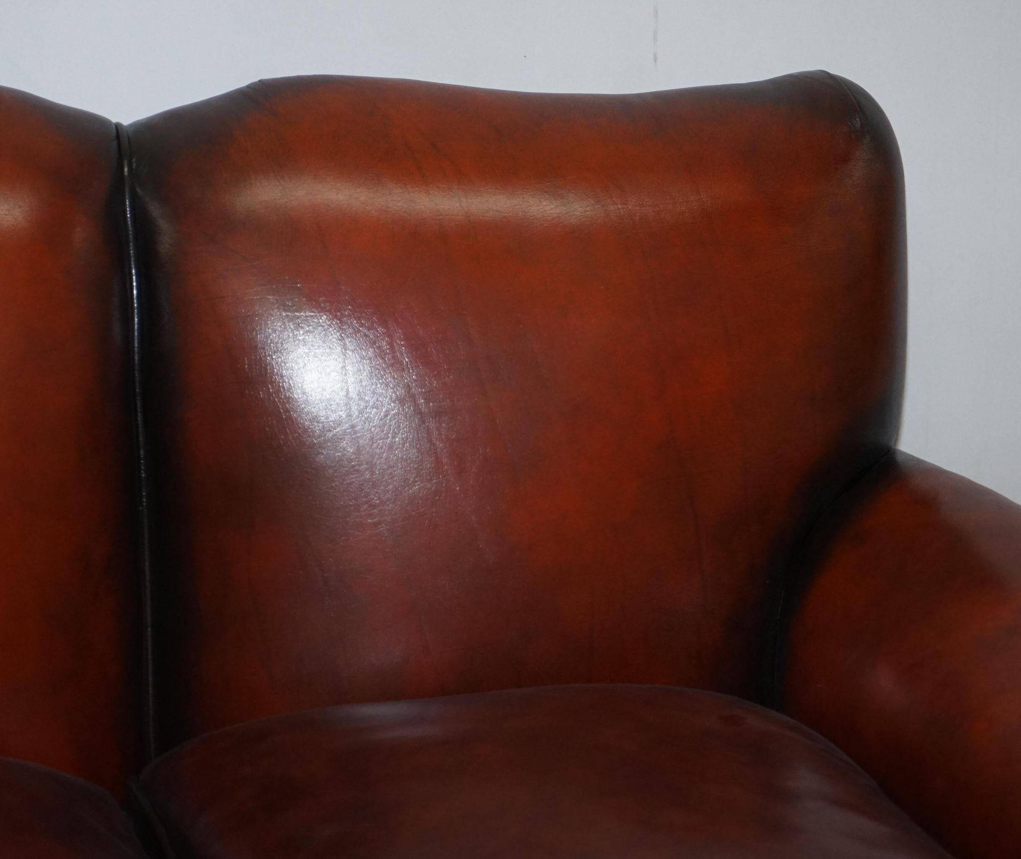 Restored Victorian sofa in leather with claw feet and feather cushions.