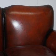 Restored Victorian sofa in leather with claw feet and feather cushions.