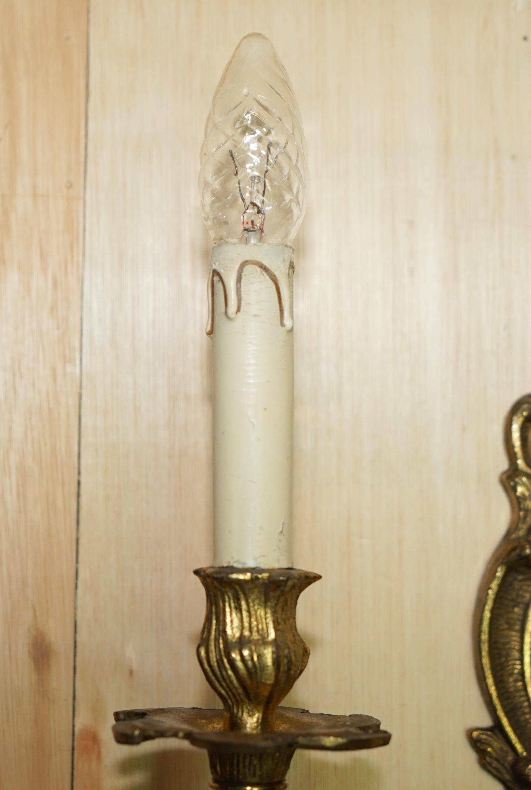 Pair of antique wall sconces from the 1920s in gilded bronze.