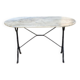 Table de bistrot marbre ovale et acier noir 4 couverts 120cm