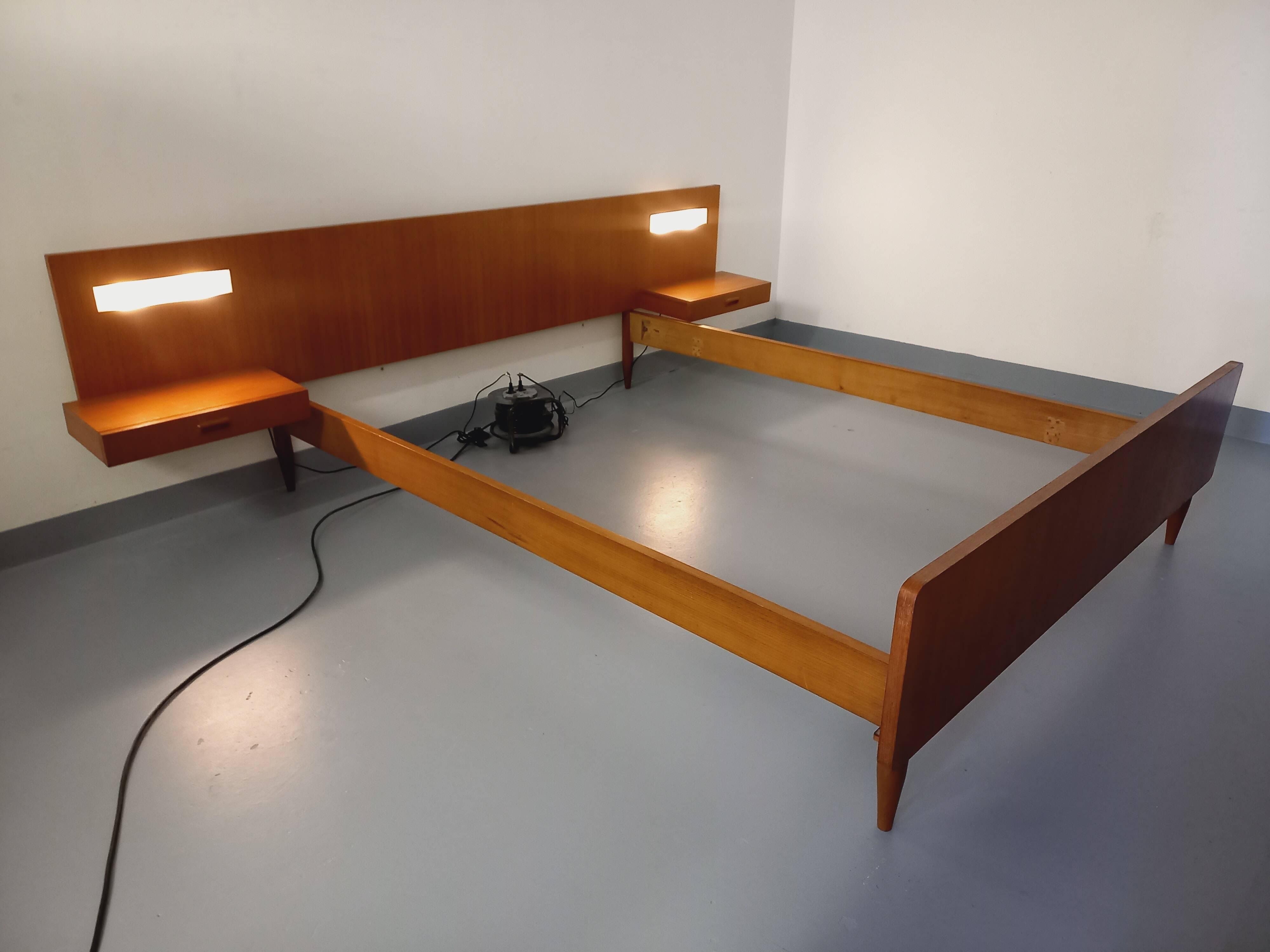 Double bed in vintage Scandinavian style from the 1960s with bedside tables.