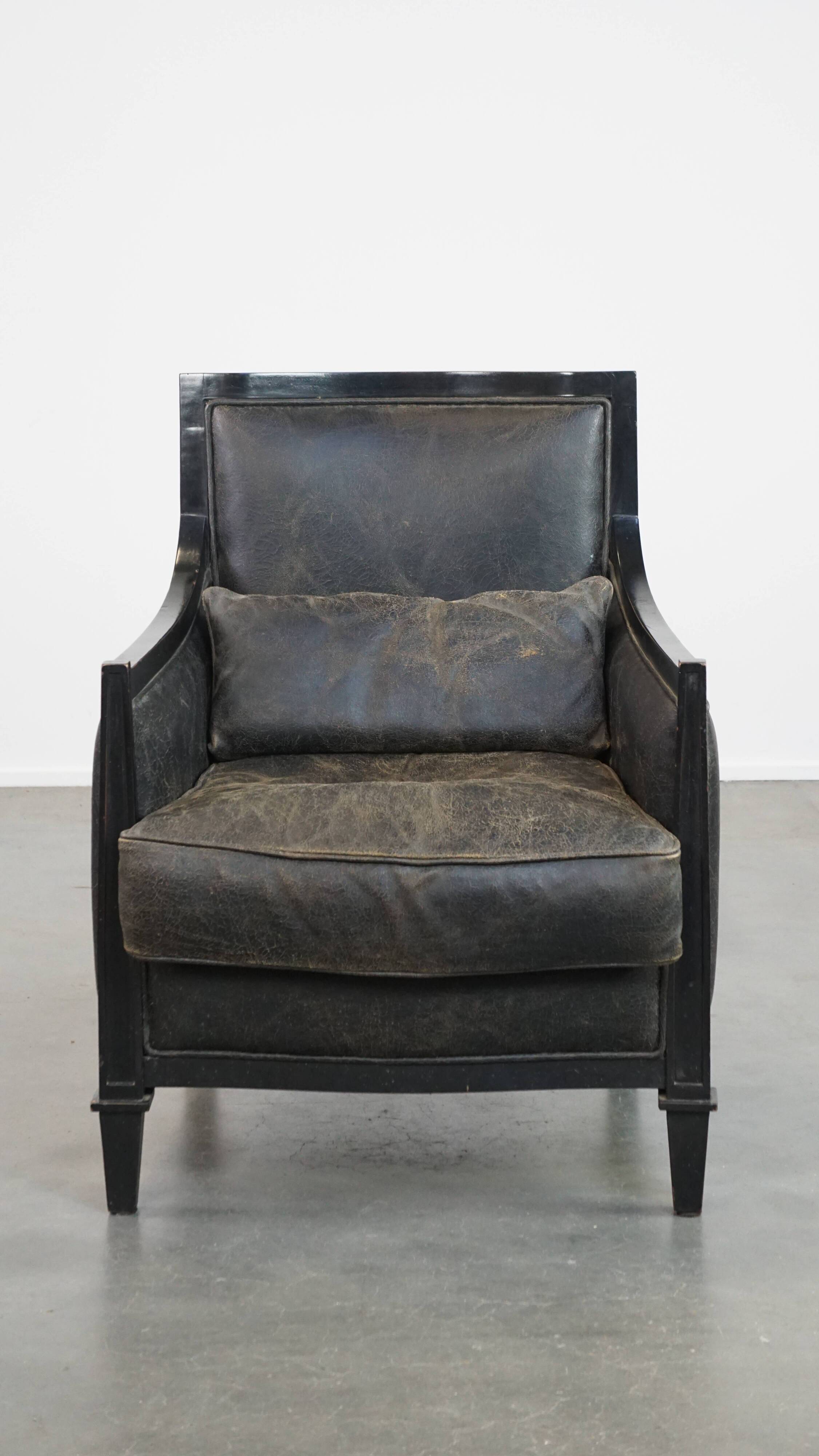 Armchair in black cowhide leather and wood with an Art Deco design