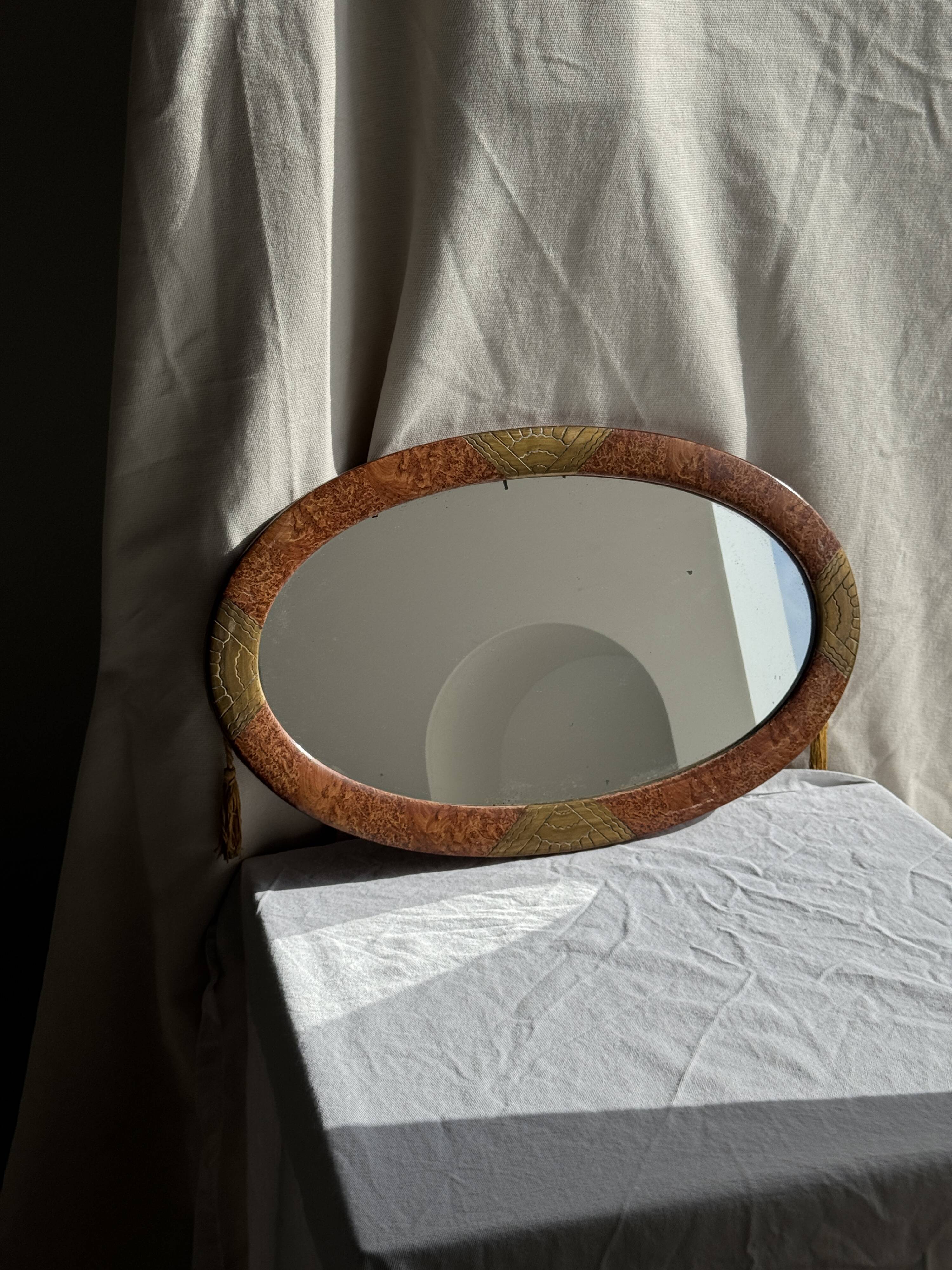 Small oval Art Deco mirror in brown and gold 33x54.