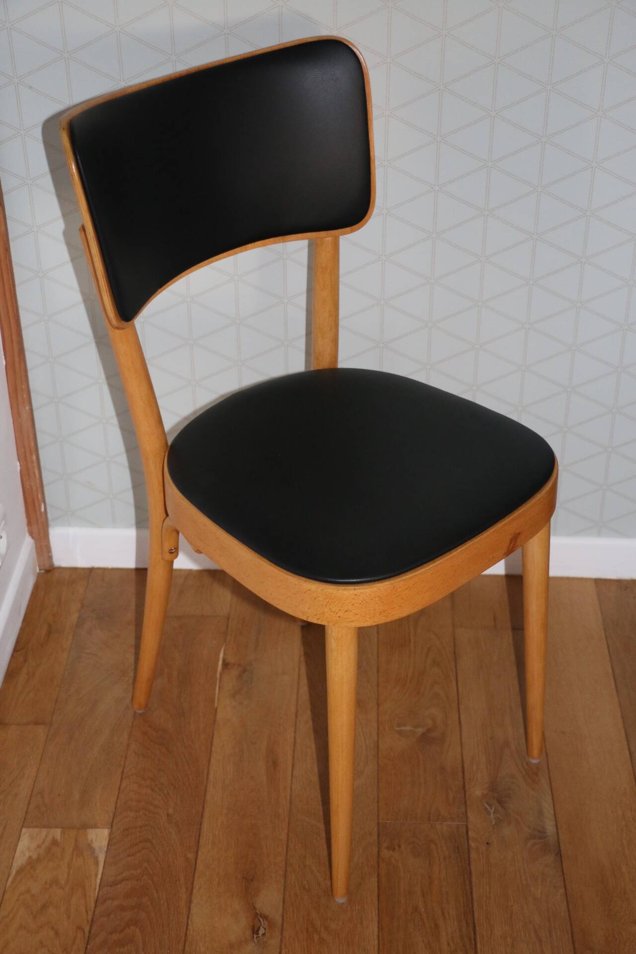 5 baumann chairs with large backs in black faux leather.